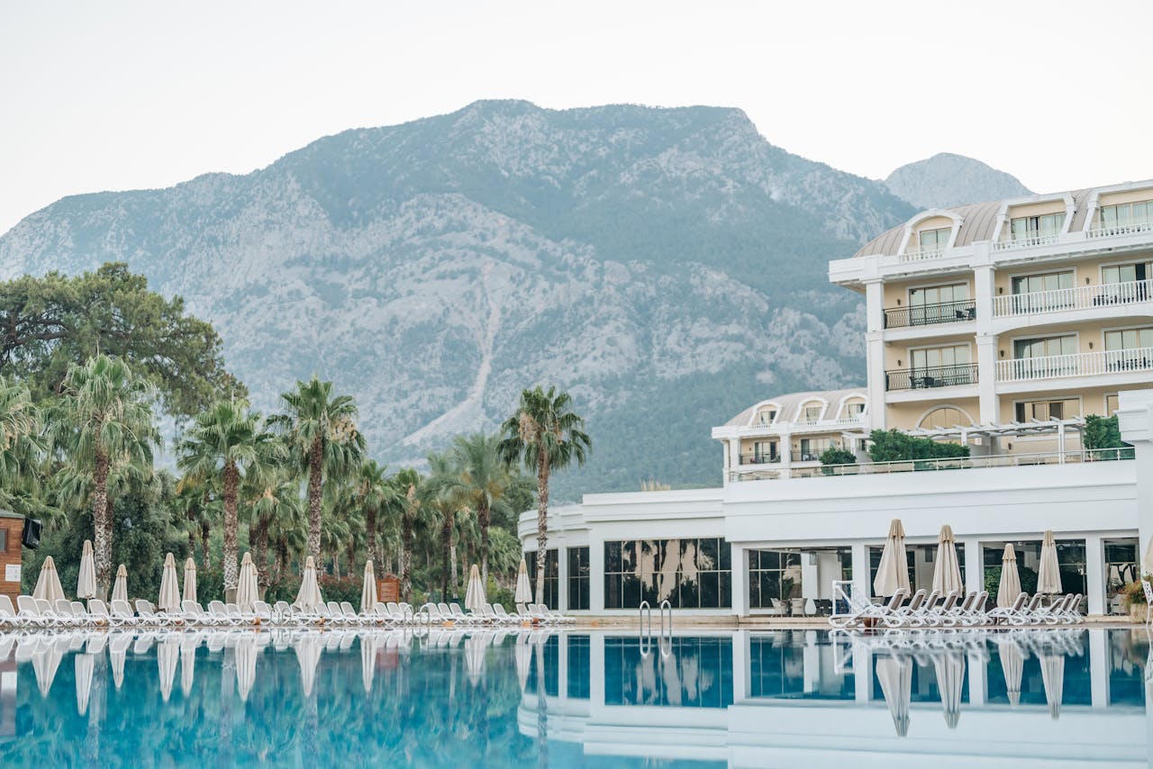Crafting Captivating Headlines: Your awesome post title goes here Tranquil luxury hotel paradise with mountain backdrop and inviting poolside setting.